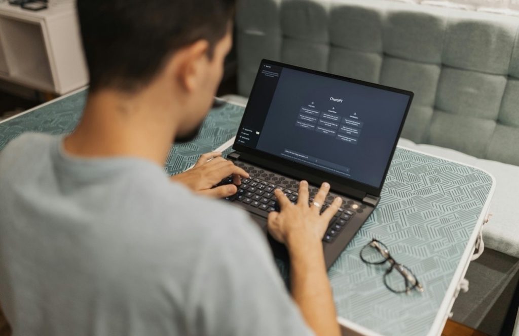 Laptop screen showing code as someone works