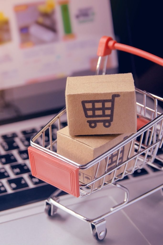 Mini cart of deliveries placed across computer keys