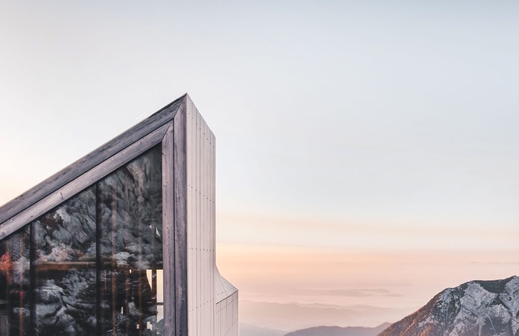 Modern wood structure under a sunset sky